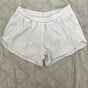 White Lululemon Athletic Shorts with Elastic Waistband and Curved Hems